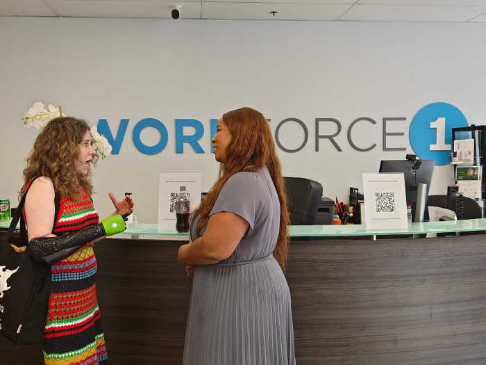 people chatting at reception workforce announcement for people with disabilities