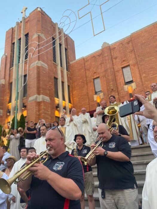 A band led the procession down 8th  Street in Williamsburg as the crowd followed closely behind.