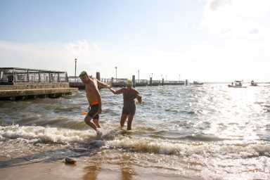 swimmers exit water after key lime pie swim
