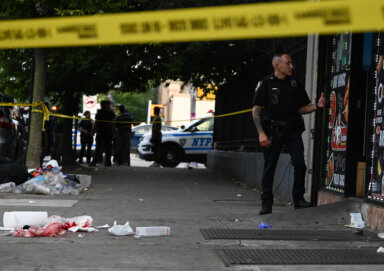 An officer from 75 precinct watched over the scene as the victim was treated.