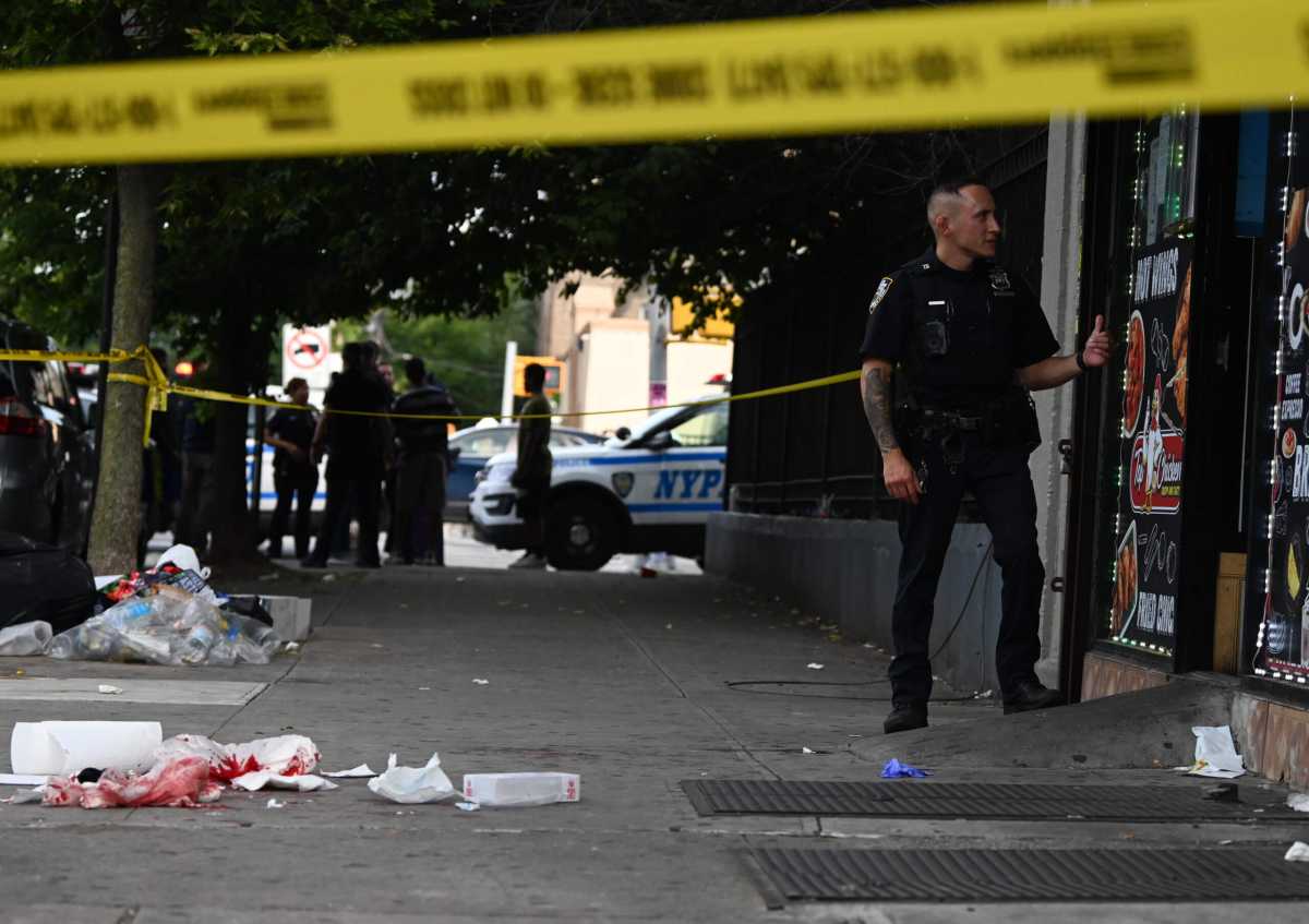 An officer from 75 precinct watched over the scene as the victim was treated.