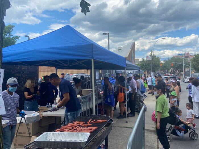 Officers barbecue for visiting community members outside the 83rd Police Precinct in Bushwick for the annual National Night Out Celebration.
