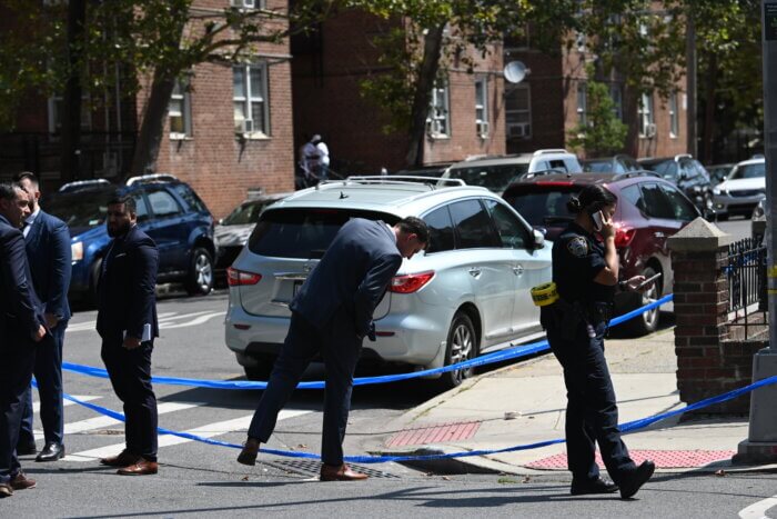 cop looking at ground on scene of wingate shooting