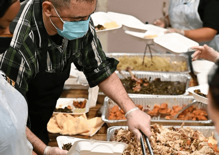 Volunteers pitch in at a Thanksgiving Meal giveaway at NSCC.