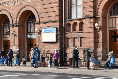 Brooklynites line up for an aid giveaway outside of the downtown church.