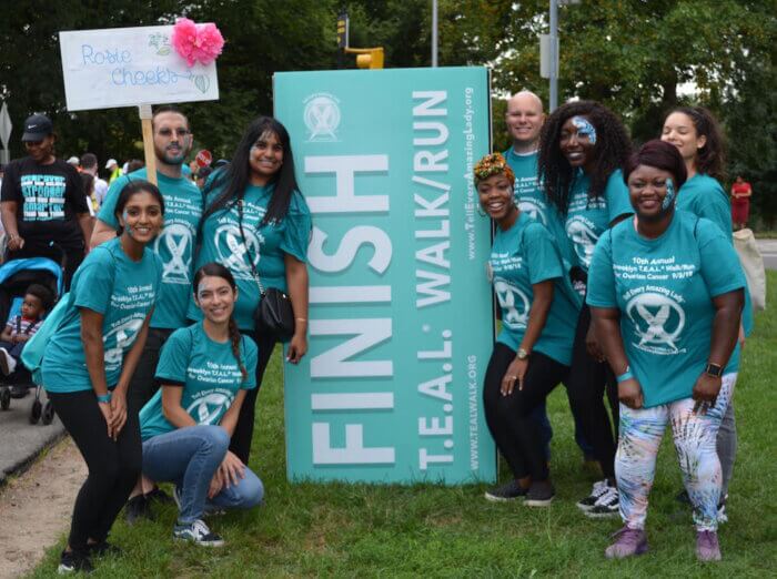 Participants pose in their matching T.E.A.L. shirts at a race