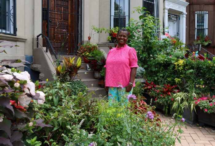 woman in yard for greenest block in Brooklyn