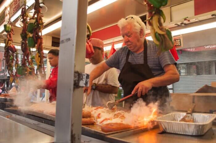 man making food at third avenue festival in bay ridge