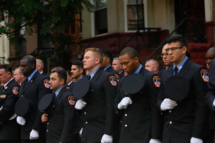 firefighters tip hats at 9/11 memorial