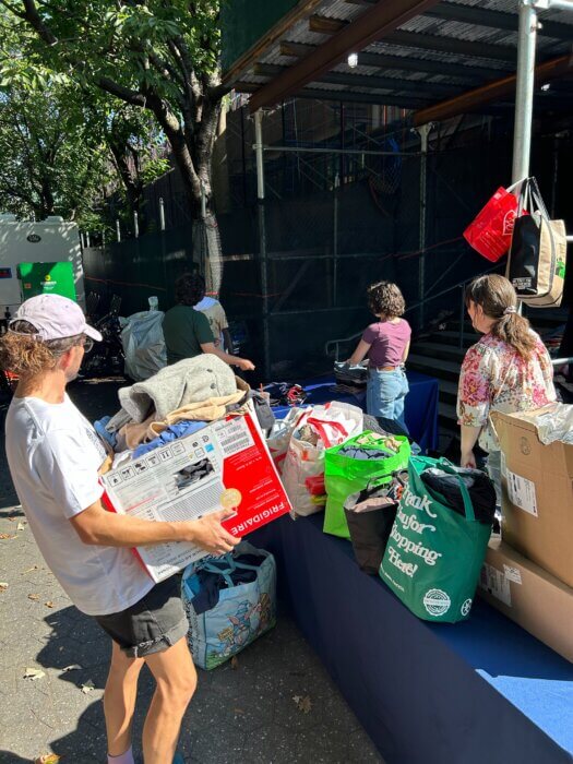 people distributing donated items to migrant shelters in brooklyn