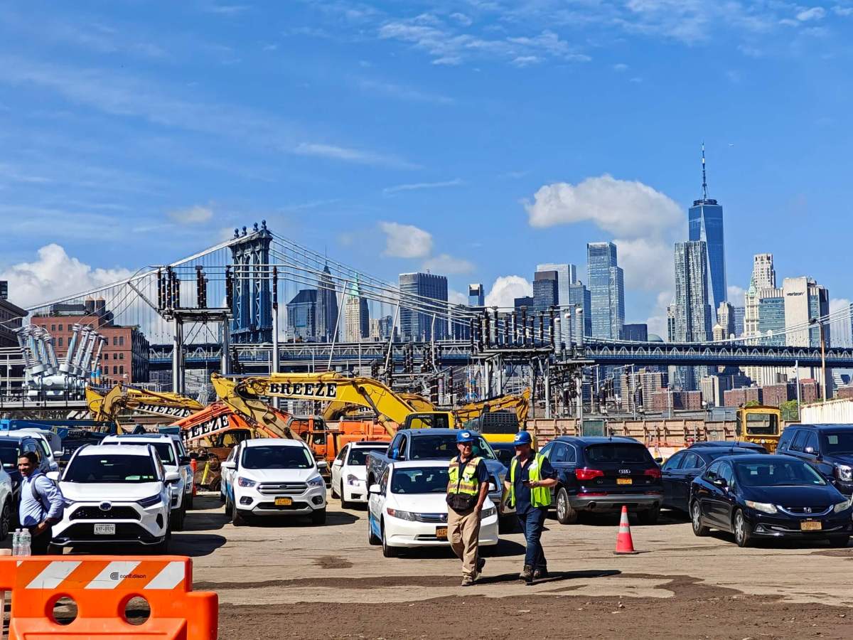 ConEd workers walk infront of the skyline at brooklyn clean energy hub