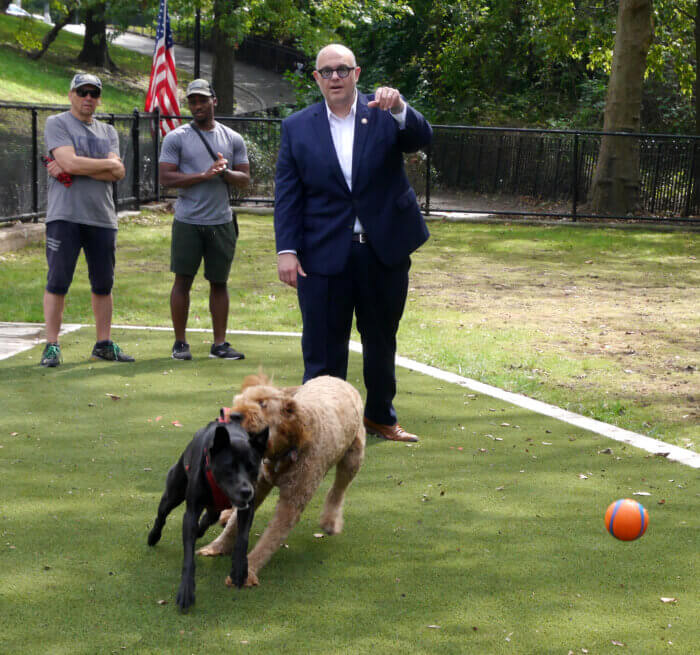 Councilman Justin Brannan tosses out the first ball at the ribbon cutting dog run on Shore Road.