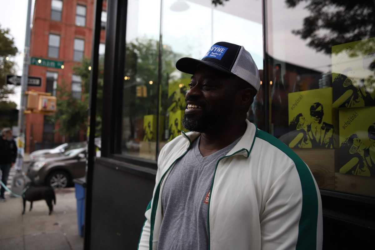 man outside his store in North Brooklyn