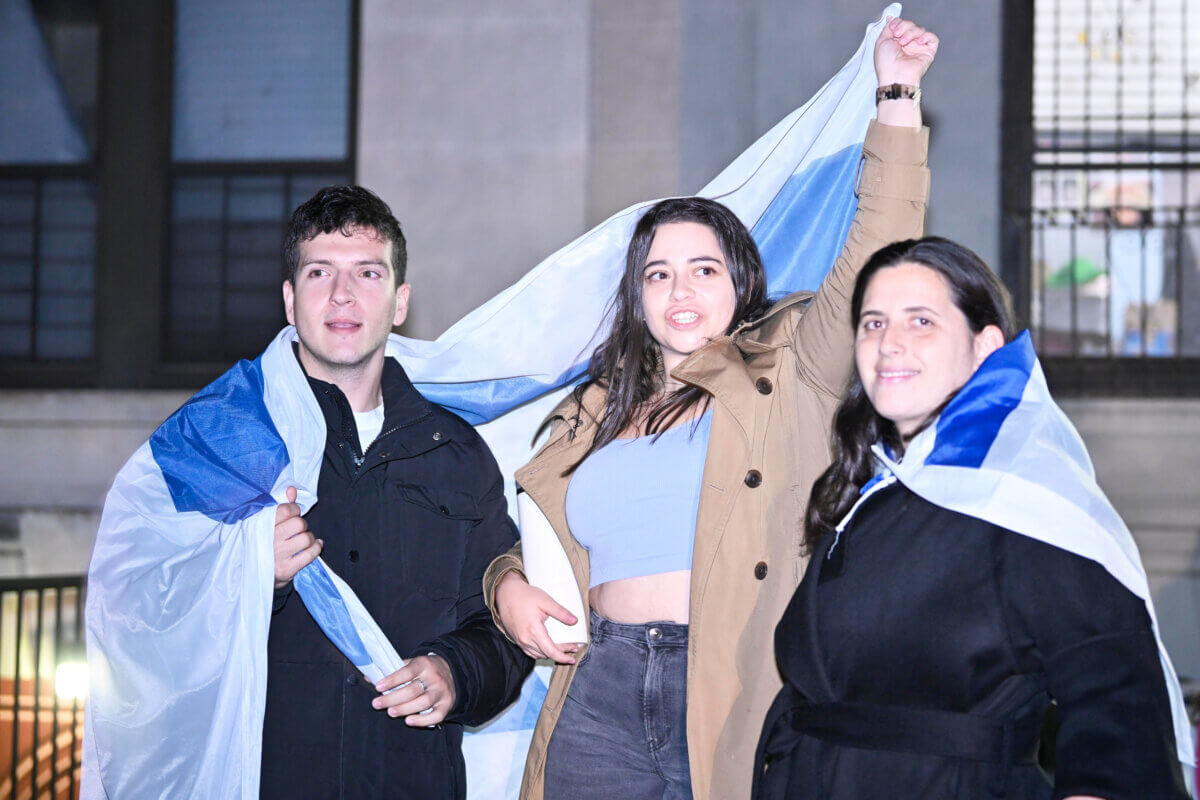 people with israel flag at rally