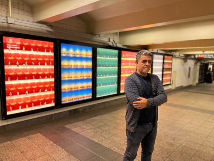 Xan padron with his exhibit in Bryant Park subway station