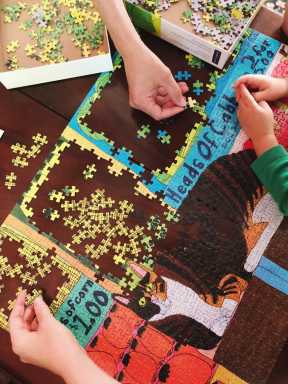 kids putting cat puzzles together