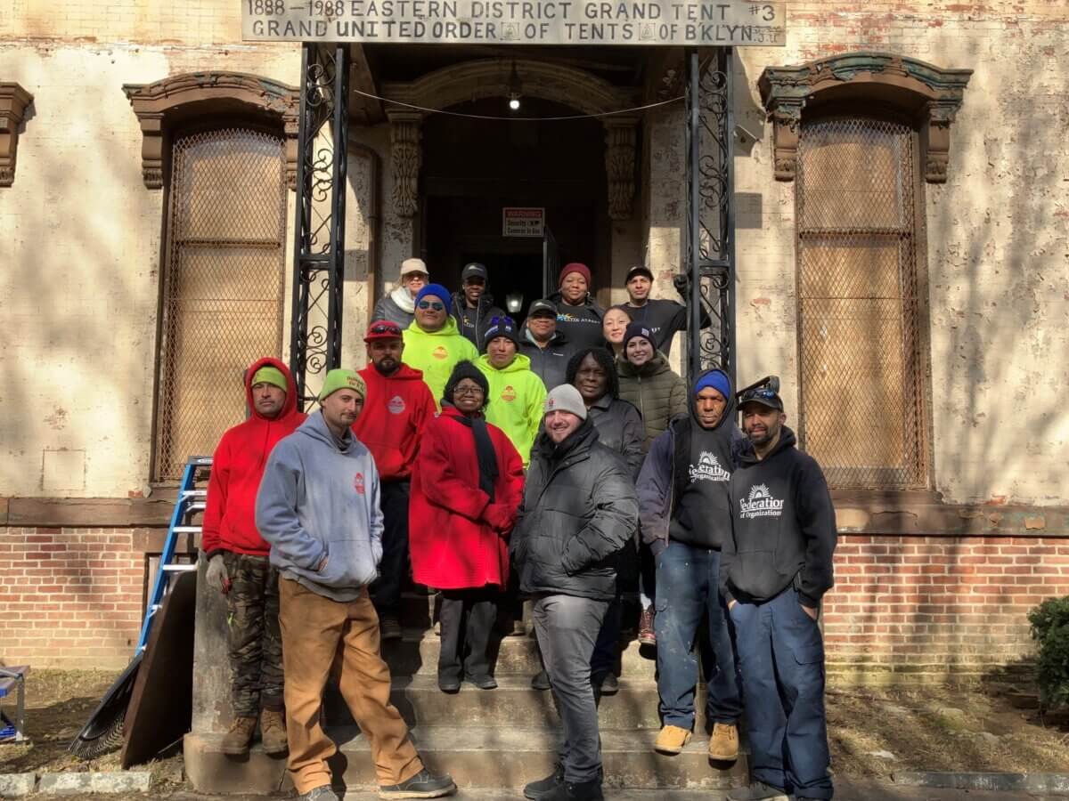 Volunteers outside united order of tents