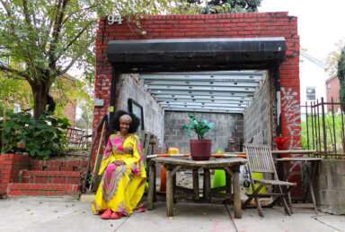 woman outside east new york house