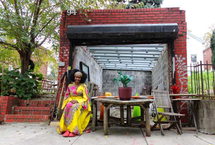 woman outside east new york house