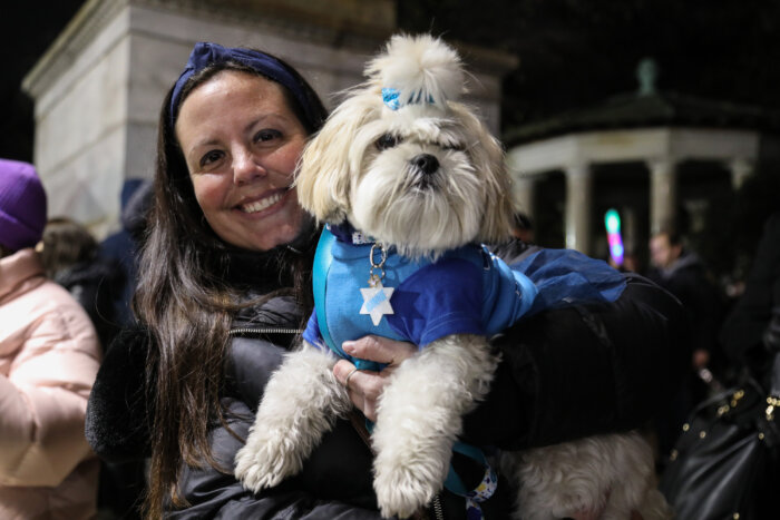 woman and dog at hanukkah celebration