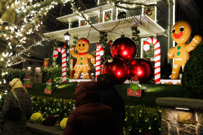 A large Gingerbread man waves from the yard of a Dyker Heights home. 