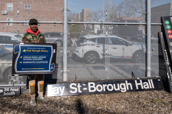 man with MTA Jay Street sign