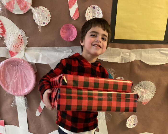 Kid with autism at Birch Family Servoces christmas gift drive