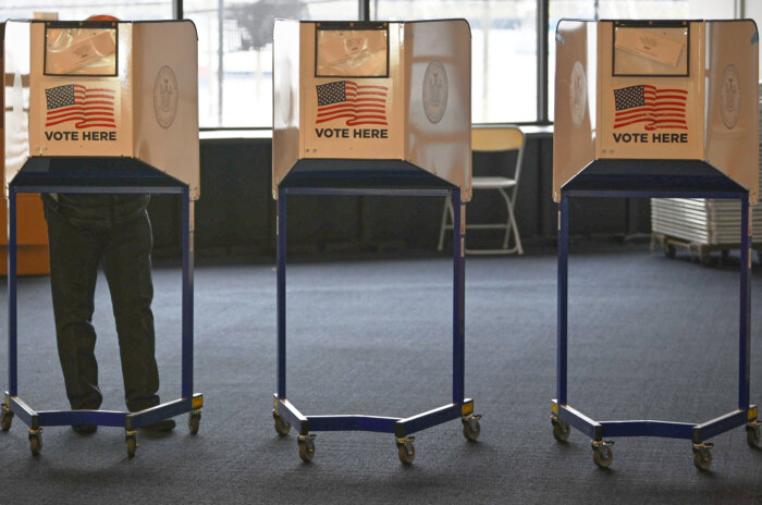 people at voting booths