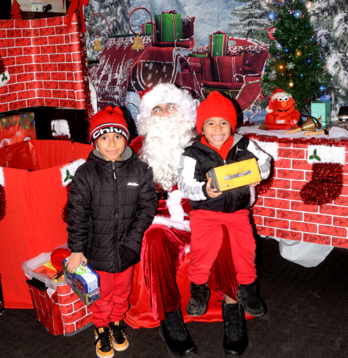 Little tots picked up free Christmas gifts during a local nonprofits toy giveaway for low income families.