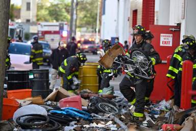 firefighter carrying e-bikes