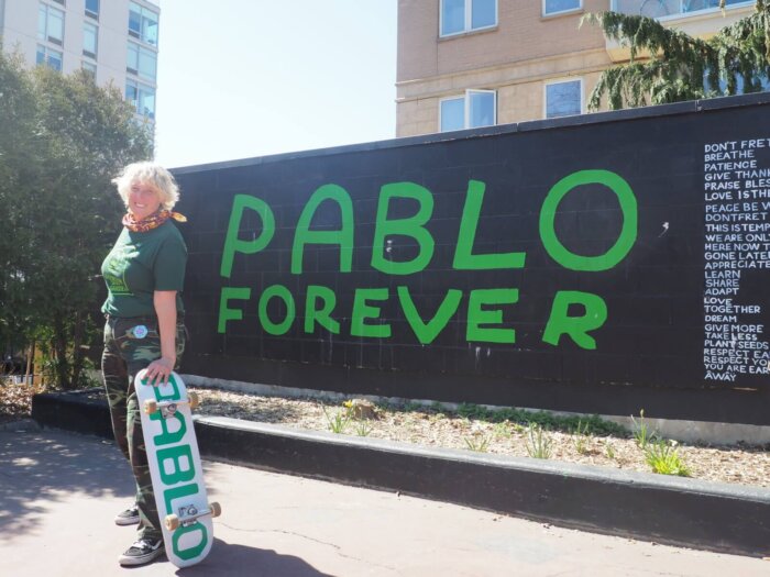 woman with skateboard at pablo wall