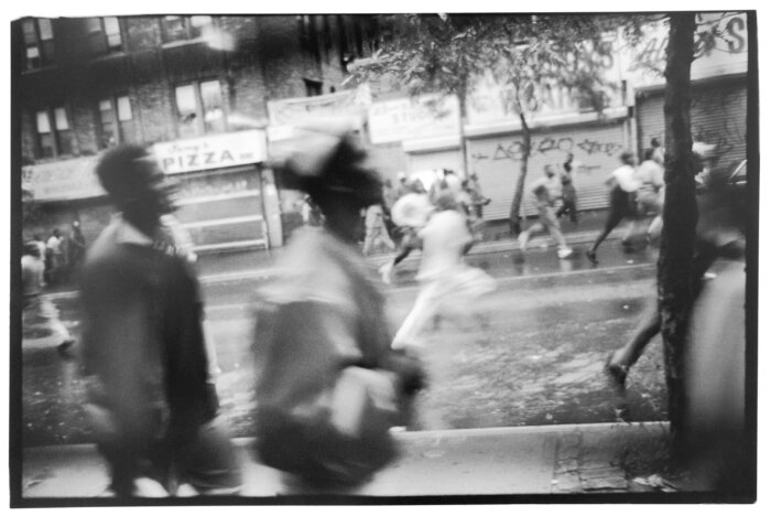 Picture by Sylvia Plachy of a crowd running down the street in Crown Heights in riots of 1991.