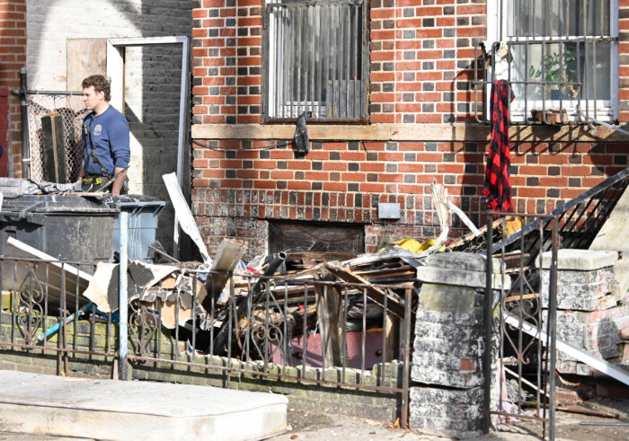 debris in yard outside apartment building