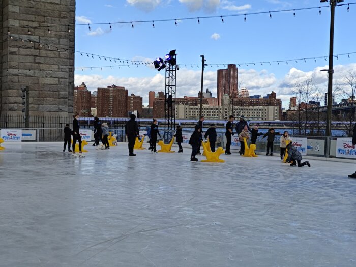 Brooklyn bridge park ice rink with williamsburg bridge view