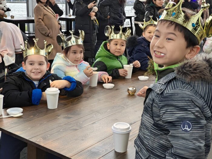 kids drinking hot chocolate at ice rink