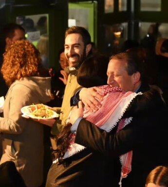 City Council Member Shahana Hanif and City Comptroller Brad Lander hug at Ayat Shabbat dinner.