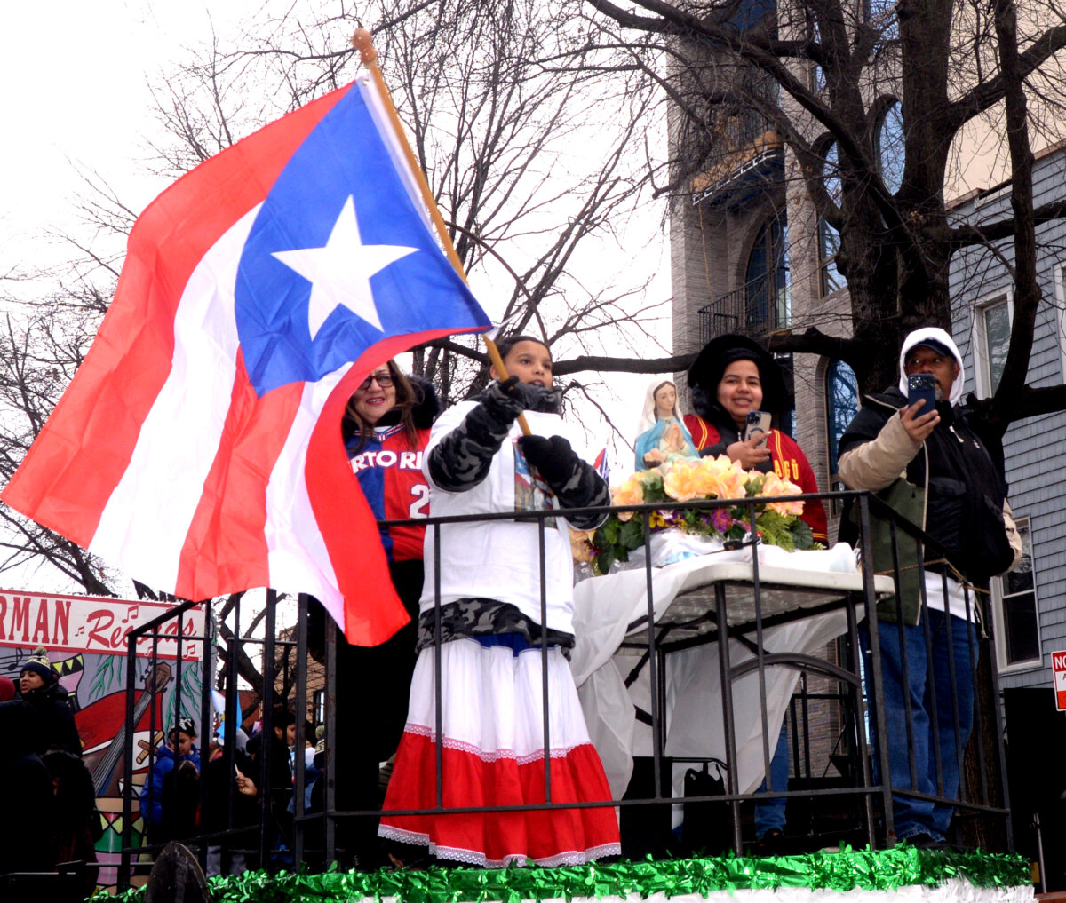 kids on float with puerto rican flag at three kings day parade