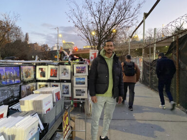 Former Brooklyn Bridge vendor standing next to table in Dumbo