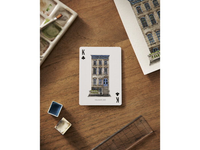 playing card with painted house on it 