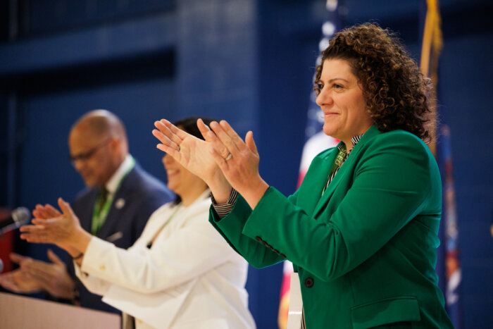 schools chief of special education clapping at announcement