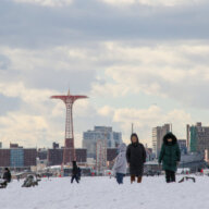 people on snowy beach in Brooklyn in February
