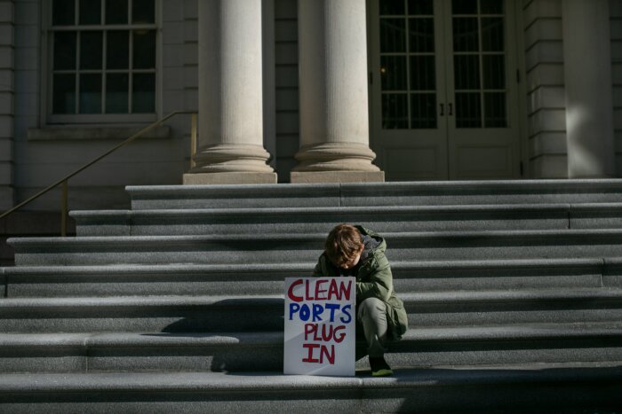 child with sign for red hook cruise ship rally