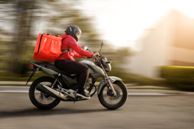 Delivery biker arriving at destination – motogirl