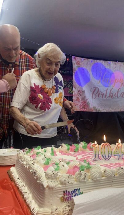 Bigelson cuts into her cake during her 104th birthday party in Coney Island