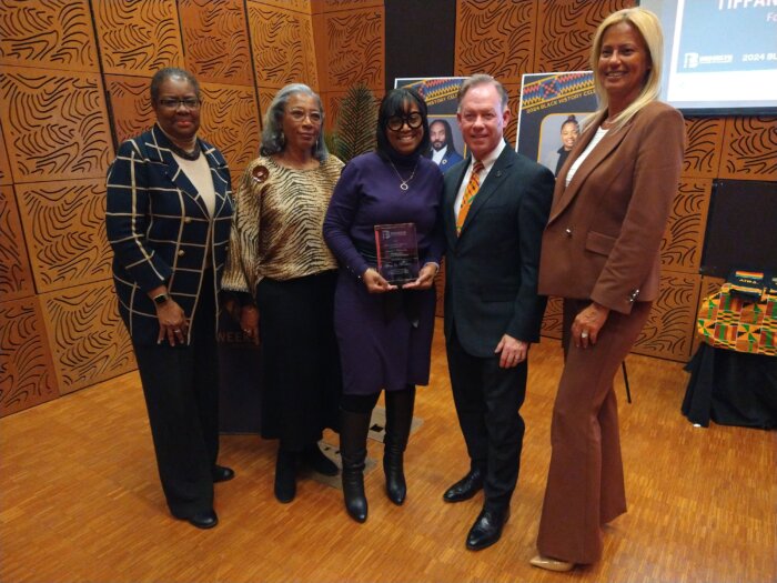 Tiffany Joy Murchison smiled with members of the Brooklyn Chamber of Commerce after receiving her award.