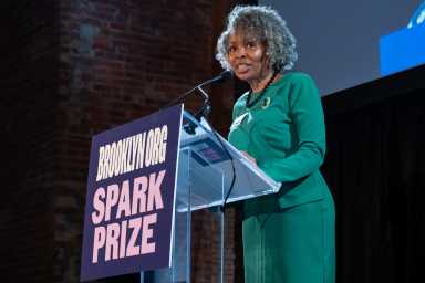 leader of the brooklyn org at spark prize podium