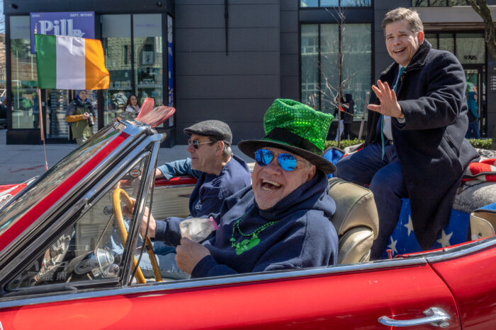 man in old car at st. patrick's day parade