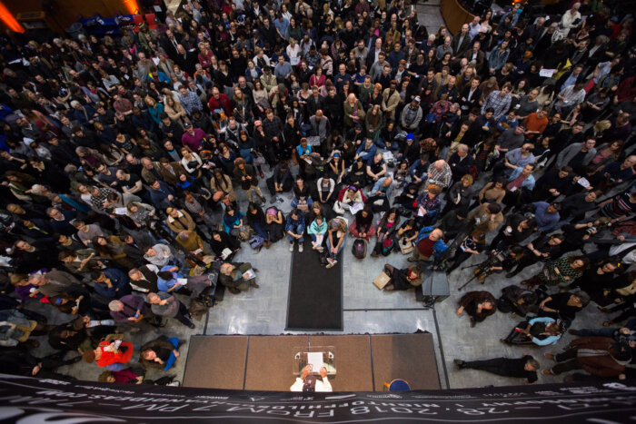 large crowd at night in the library