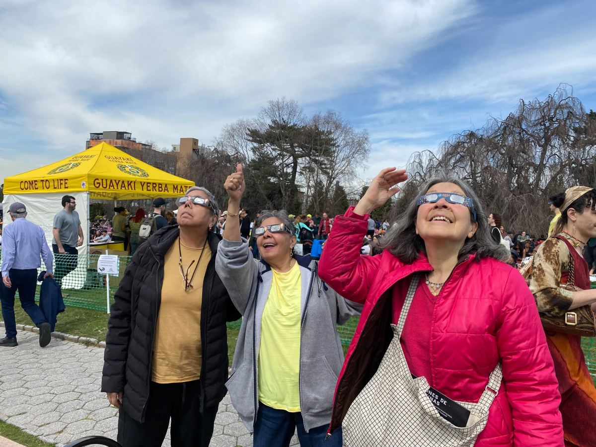 women in eclipse glasses at Green-Wood cemetery