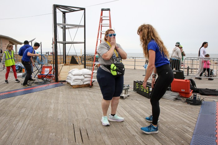 woman celebrating after finishing brooklyn half marathon